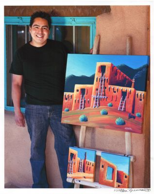 Gary David Suazo standing beside his artwork